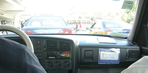 On the dashboard on the passenger side is a placard with the drivers registration number